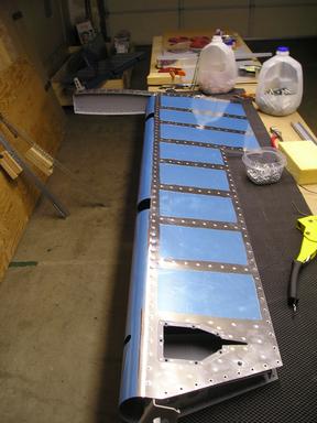 Riveted counterbalance assembly to front spar