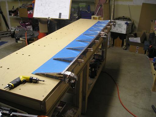 Lower skin and spar laying in cleco holes on table
