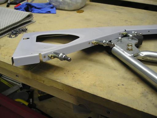 Riveting nutplates on ribs