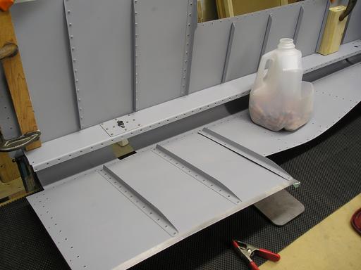 Back-riveting stiffeners to bottom skin