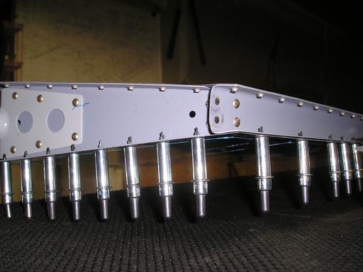 Riveting trim tab spar to skin and inner rib