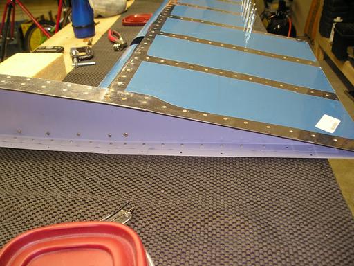 Riveting counterbalance assembly to skin