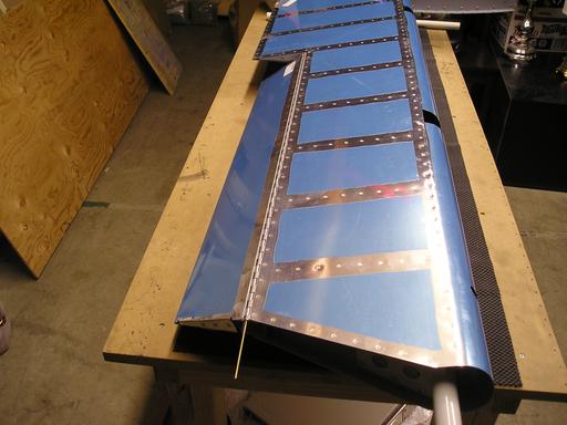 Trim tab assembled to elevator