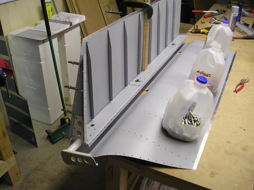 Riveting upper skin to spar
