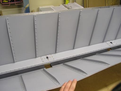 Lower skin stiffeners riveted to skin