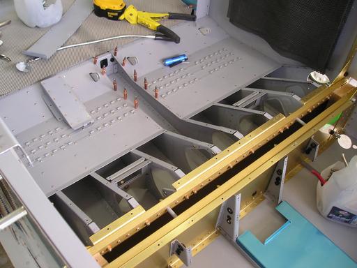 Seat belt brackets riveted in