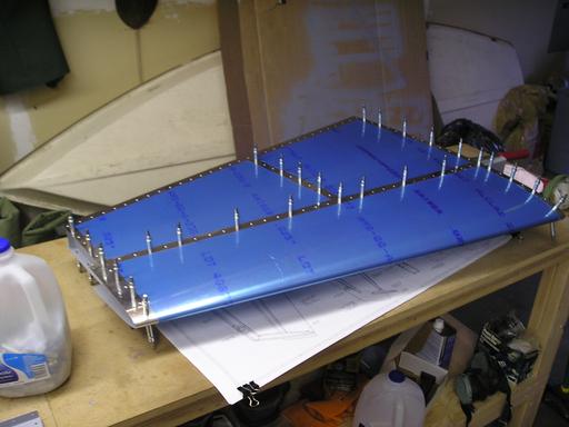 Riveting ribs to front spar, cleco'ing skin to front spar and ri